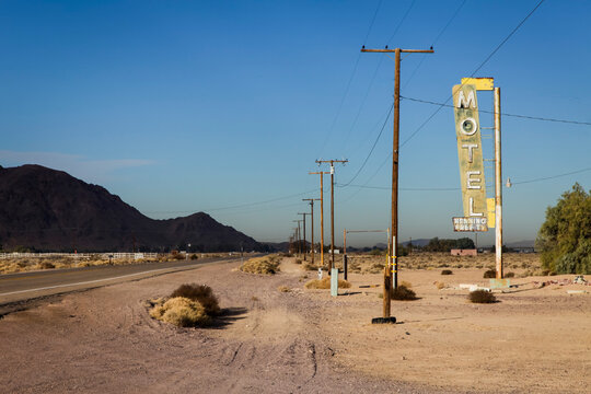 Abandoned vintage motel sign along desert roadside