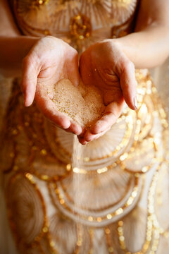 Sand falling through hands symbolizing time passing or loss