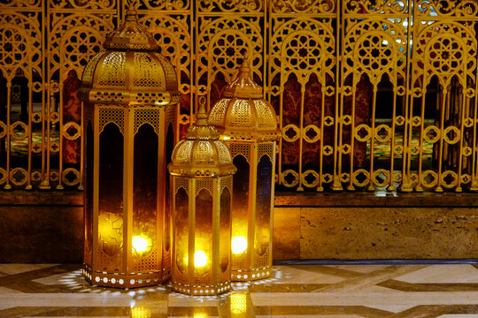 Glowing Moroccan lanterns with ornate metal screen
