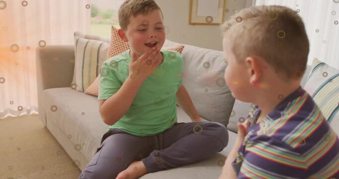 Two boys practicing family greeting after left boy starting to talk, bubble overlay marking hands