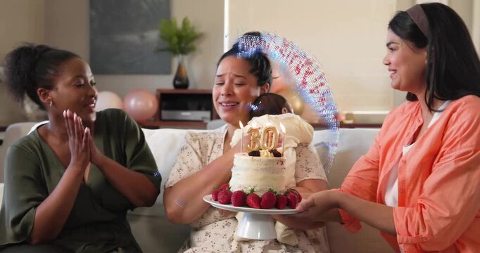 Right woman presenting 30th birthday cake, swirl revealing cake, center woman holding baby
