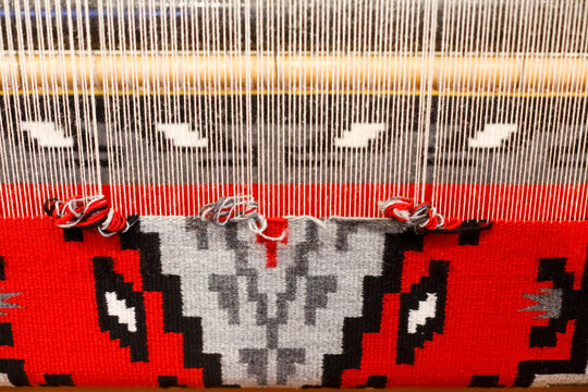 Traditional weaving in progress on upright loom