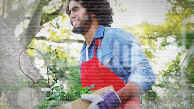 Gardener in red apron lifting crate, then carrying plants for gardening, light glare crossing frame