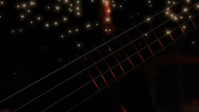 Musician hand entering frame, plucking strings and producing bass tones, fretted neck glowing