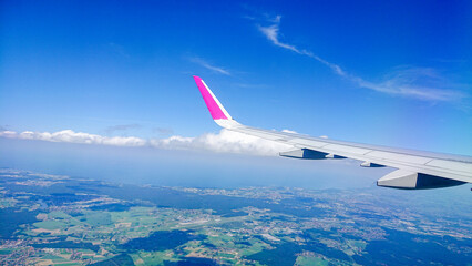 Aftersunset sky, bright blue, dotted with soft white clouds