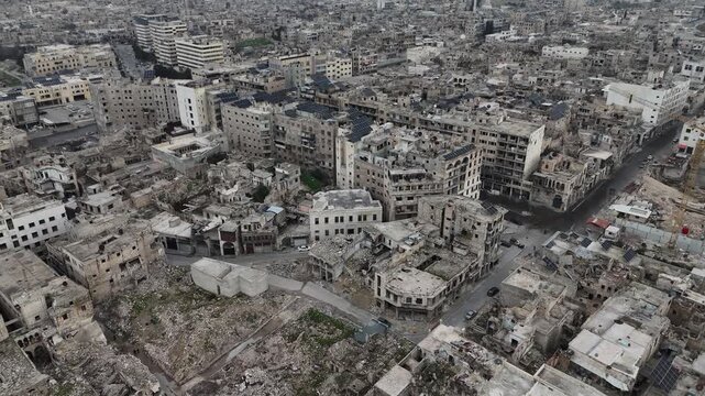 aerial drone footage of Citadel of Aleppo and the dense historic Old City in Syria, showcasing ancient architecture and urban heritage