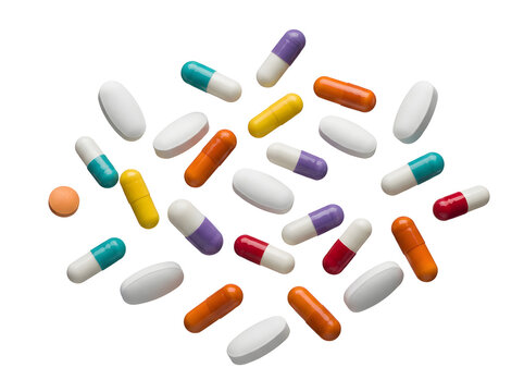 Selection of colorful medical pills and capsules scattered on a stark black background isolated on transparent background