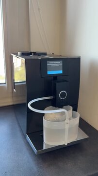 The self-cleaning coffee machine, equipped with a cappuccino frother, is connected to a water tank for cleaning the brew unit, the cappuccino frother, and the milk system.