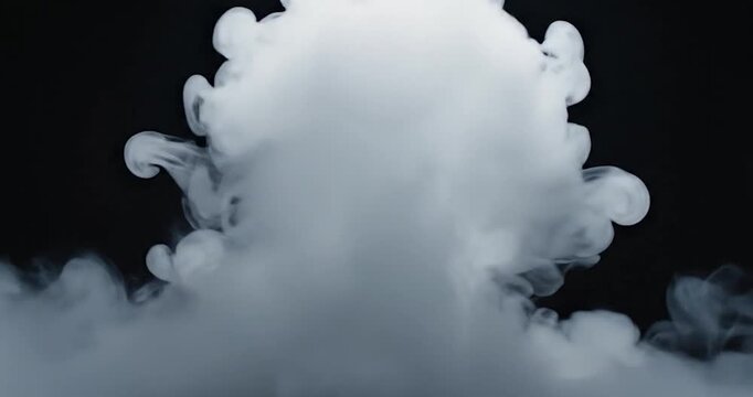 Thick white smoke rising on a dark black background