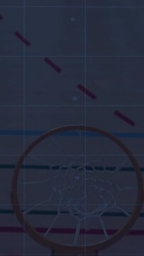 Vertical video: Basketball entering left arcing over rim contacting net passing through for sports