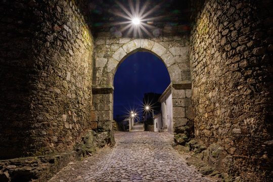 Evoramonte village castle gate at night in Alentejo