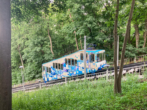 Blue and white miniature train on a forest track in Kyiv funicular railway - Kyiv, Ukraine 06-16-2025