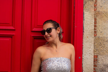 Fototapeta premium portrait of a beautiful young woman smiling at camera in old town