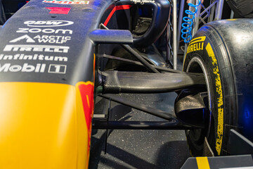 Fototapeta premium Red Formula 1 car on display, red, white, black accents, Infiniti, Mobil sponsor logos, aerodynamic design, front wing assembly with adjustable elements, complex str - Kyiv, Ukraine - June 8, 2025