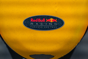 Fototapeta premium Close-up view of a yellow Red Bull Formula One car, prominently displaying the Red Bull logo on a black background The vehicle is vibrant and dynamic with red, blue - Kyiv, Ukraine - June 8, 2025