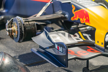 Fototapeta premium Red Bull Formula 1 car part on dark background, predominantly red, white, yellow, black color scheme, vibrant contrast, commercial sponsorship, exposed steering whee - Kyiv, Ukraine - June 7, 2025