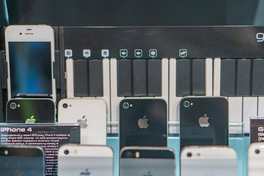 Close-up of multiple Apple iPhones, varying models, black protective covers, soft lighting, new or well-maintained condition, potential sale or exhibit, commercial s Kyiv, Ukraine - September 14, 2025
