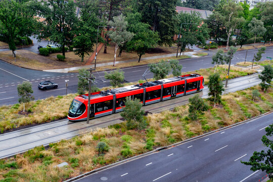 light rail track in Canberra with a red train from above
