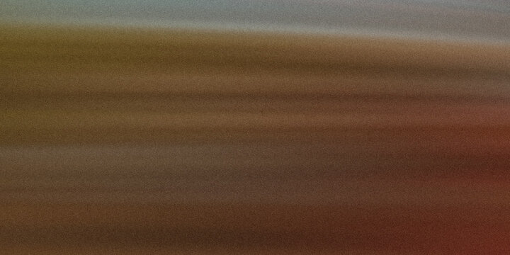 a blurry image of a brown and red field with a gray sky