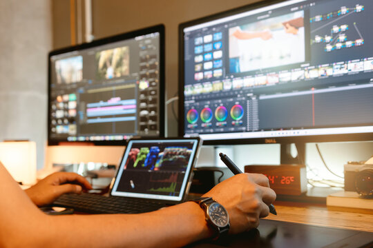 Colorist are color grading a new film or video in his professional studio. Close-up shot