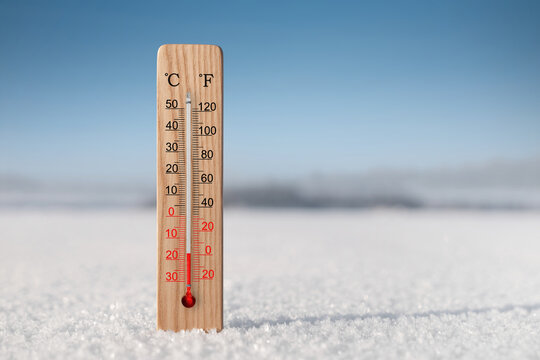 White celsius and fahrenheit scale thermometer in snow. Ambient temperature minus 17 degrees celsius