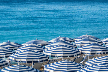 Rows of Blue and White Striped Beach Umbrellas on Nice Coast