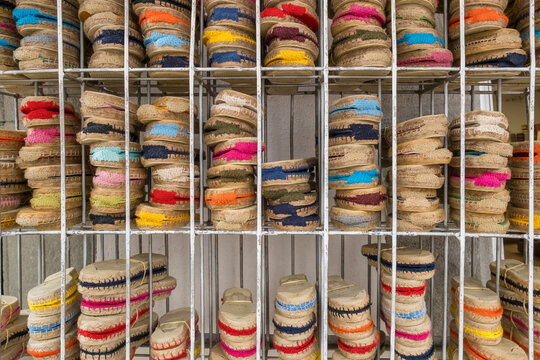Rows of traditional colorful Spanish espadrilles on a metal rack