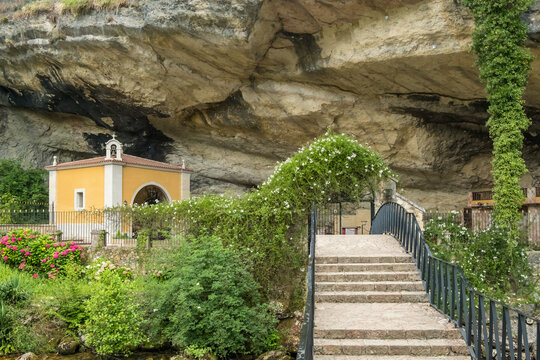 The Yellow Chapel of the Santuario de la Virgen de la Cueva by a Rock Overhang