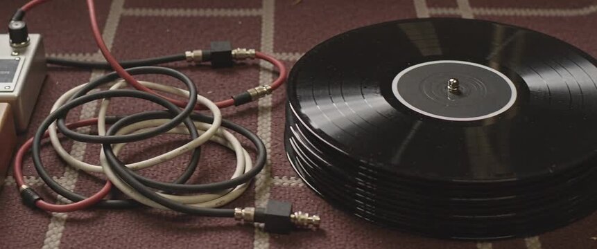Vintage Music And Analog Audio Concept Stack Of Vinyl Records With Cables On Rug Retro Technology And Music.