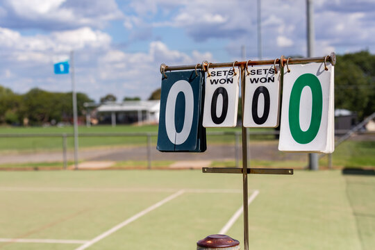 Rural town tennis court with scoring system showing sets won
