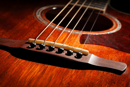 acoustic guitar bridge on black background