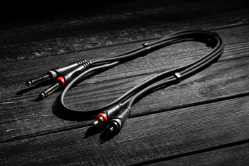 rca ts audio cable on black wood background