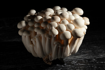 enoki mushroom on black wood background