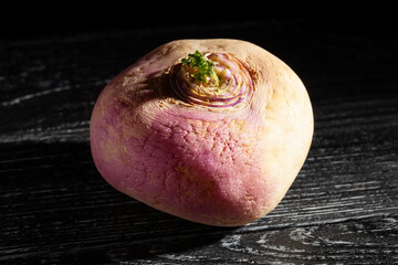 turnip on black wood background