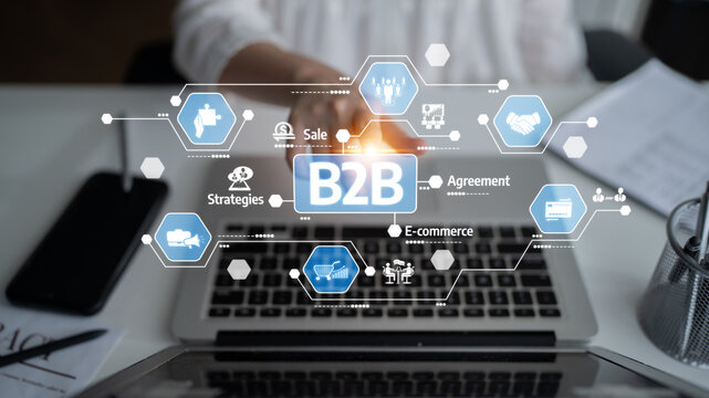 Close-up of a laptop displaying B2B marketing strategy with icons for e-commerce and sales agreements, highlighting key business concepts in a modern workspace. Tessel