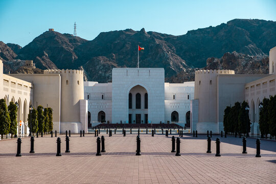 The National Museum - Sultanate of Oman with background of Hajar mountains and national flag of Oman