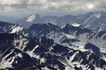 The enchanting beauty of the snowy mountains. The view of snow and rocks on the mountain tops.