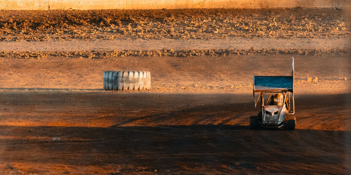 Junior winged sprint car on the race track at the speedway with copy space