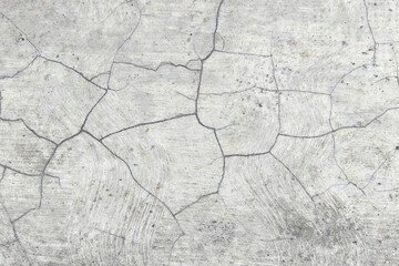 Obraz premium Cracked concrete floor texture with grey cement surface. Close-up of aged pavement with intricate fracture patterns and weathered industrial detail for background.