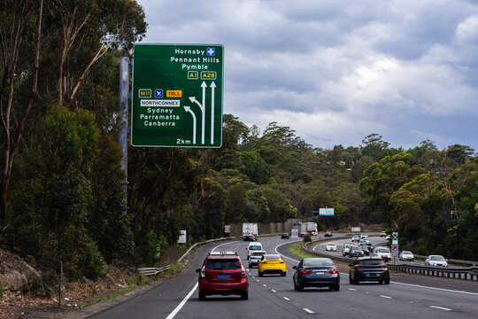 busy highway road into Sydney with sign giving directions to Hornsby and Pennant Hills