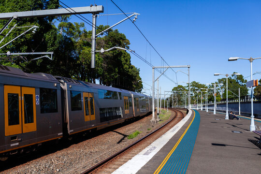 Passenger train passing platform of Narwee station in Sydney suburb