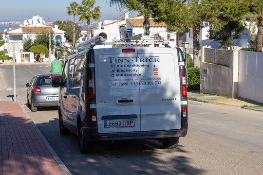 Torrevieja, Spain - January, 12 2026: A white Renault Trafic service van, equipped with a roof rack, ladders, and a pipe storage tube, is parked on a sunlit residential street