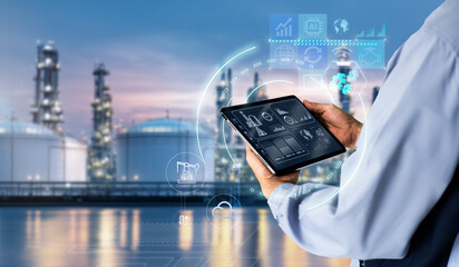 Oil and gas refinery system management concept.engineer using digital tablet controlling smart...