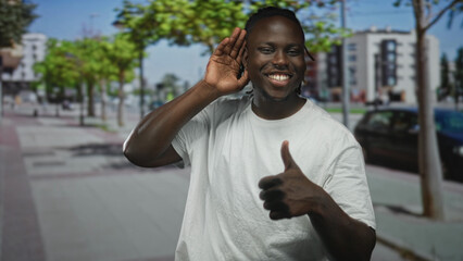Fototapeta premium Man cupping ear with hand on a city street sidewalk, glancing toward traffic and parked cars while listening intently; curiosity.