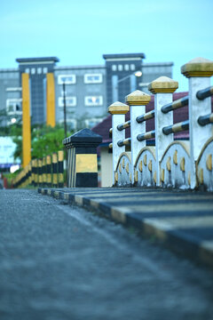 Weathered concrete railing with yellow and black railings