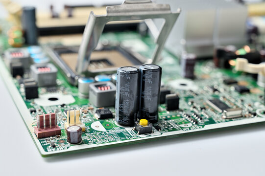 Close-up view of a computer motherboard with capacitors and CPU socket