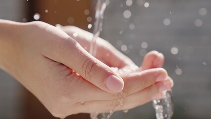 a stream of wet transparent clean water is poured onto the hands, observe the hygiene of clean...