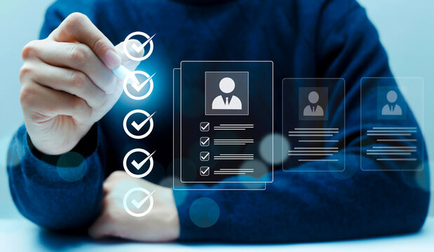 Hand selecting candidate profile with check mark icons on virtual interface, representing recruitment process, HR screening, employee selection and talent acquisition. Concept of hiring.
