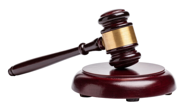 Isolated classic wooden judge's gavel resting on sound block, representing justice and law