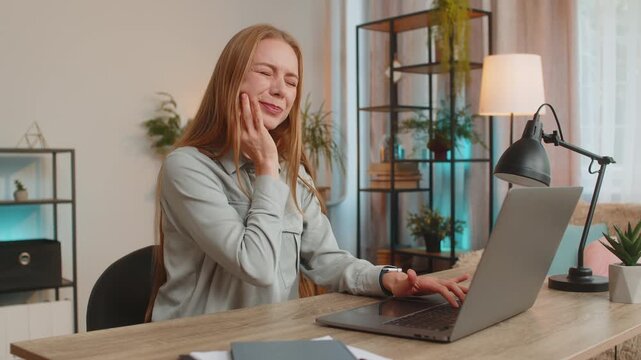 Caucasian mature businesswoman freelancer sitting at home office table feeling toothache touching mouth with hand, painful expression because of dental illness. gum disease, dental disease concepts.